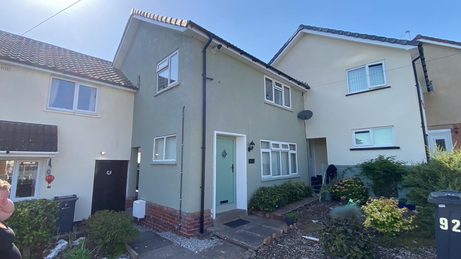 Rendered House Painted Sage Green Rendered semi-detached house exterior painted sage green with white windows and a pale green composite front door