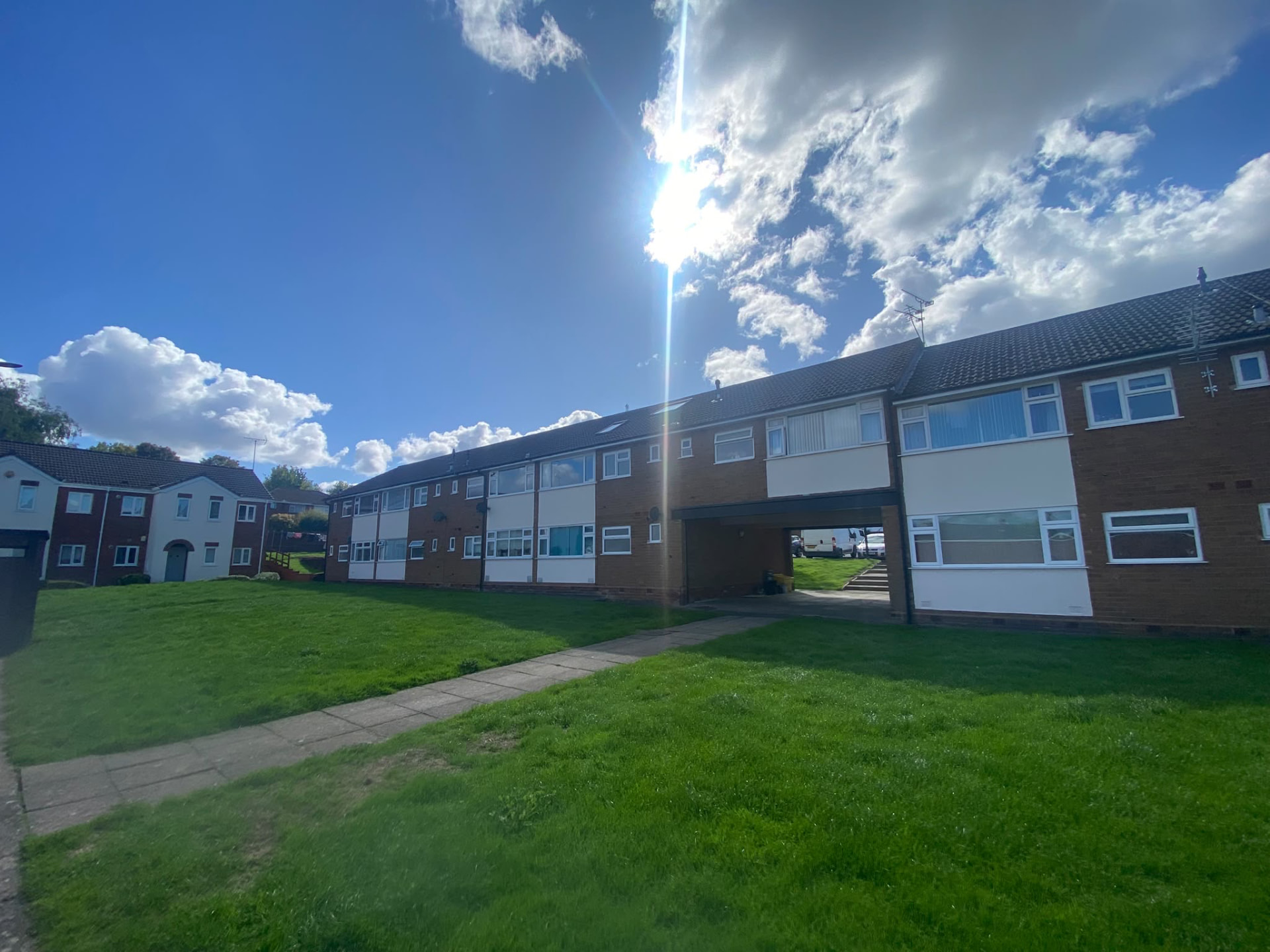Wide view of completed exterior painting at Sutton Court