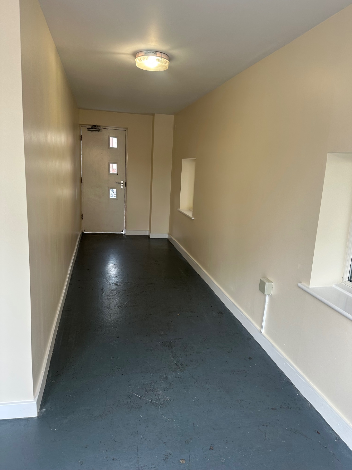 Communal ground-floor entrance hallway repainted with fresh emulsion and satin woodwork