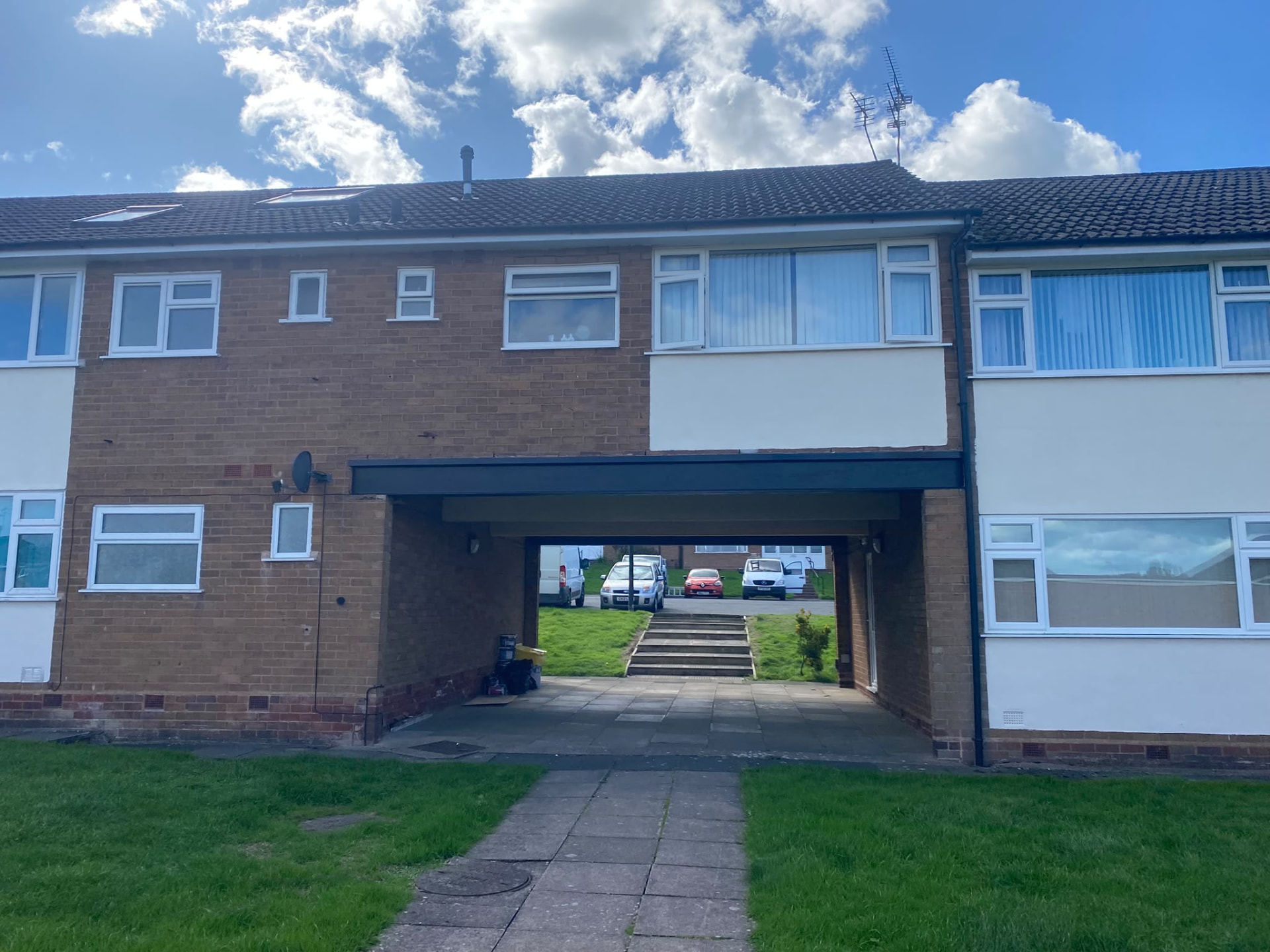 Painted residential block and covered walkway at Sutton Court